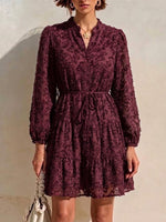 Long-sleeve, Short Dress Featuring A V-neck, Partial Button Placket, Tie-waist, And Ruffled Hem, Crafted From Jacquard Fabric With A Cut-out Floral Design