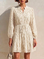 Long-sleeve, Short Dress Featuring A V-neck, Partial Button Placket, Tie-waist, And Ruffled Hem, Crafted From Jacquard Fabric With A Cut-out Floral Design