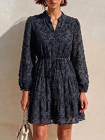 Long-sleeve, Short Dress Featuring A V-neck, Partial Button Placket, Tie-waist, And Ruffled Hem, Crafted From Jacquard Fabric With A Cut-out Floral Design