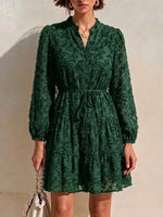 Long-sleeve, Short Dress Featuring A V-neck, Partial Button Placket, Tie-waist, And Ruffled Hem, Crafted From Jacquard Fabric With A Cut-out Floral Design